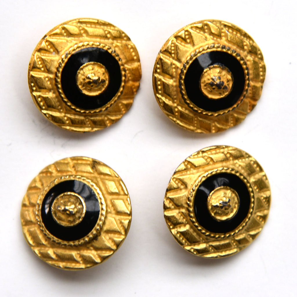 Gold shield buttons with black and gold center, closeup