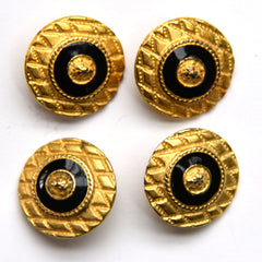 Gold shield buttons with black and gold center, closeup