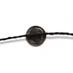 Unlabeled black wool yarn cone  thread view